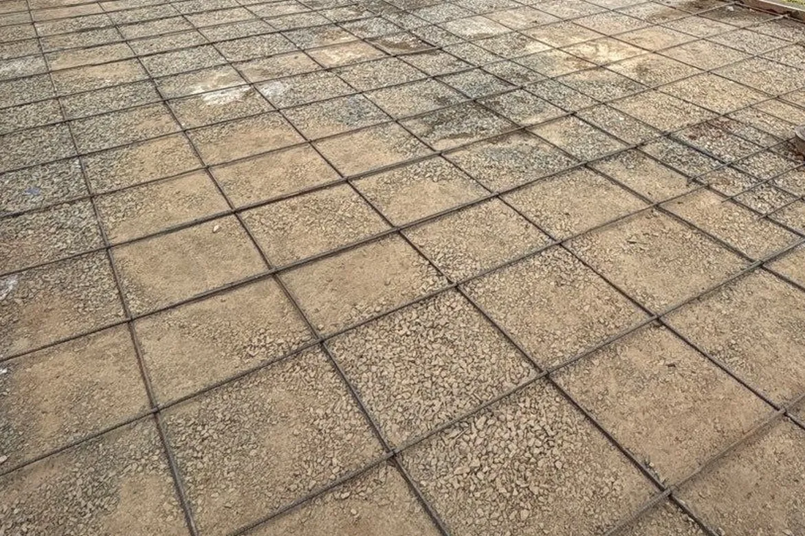 Compacted base and rebar grid prepared before a concrete pour